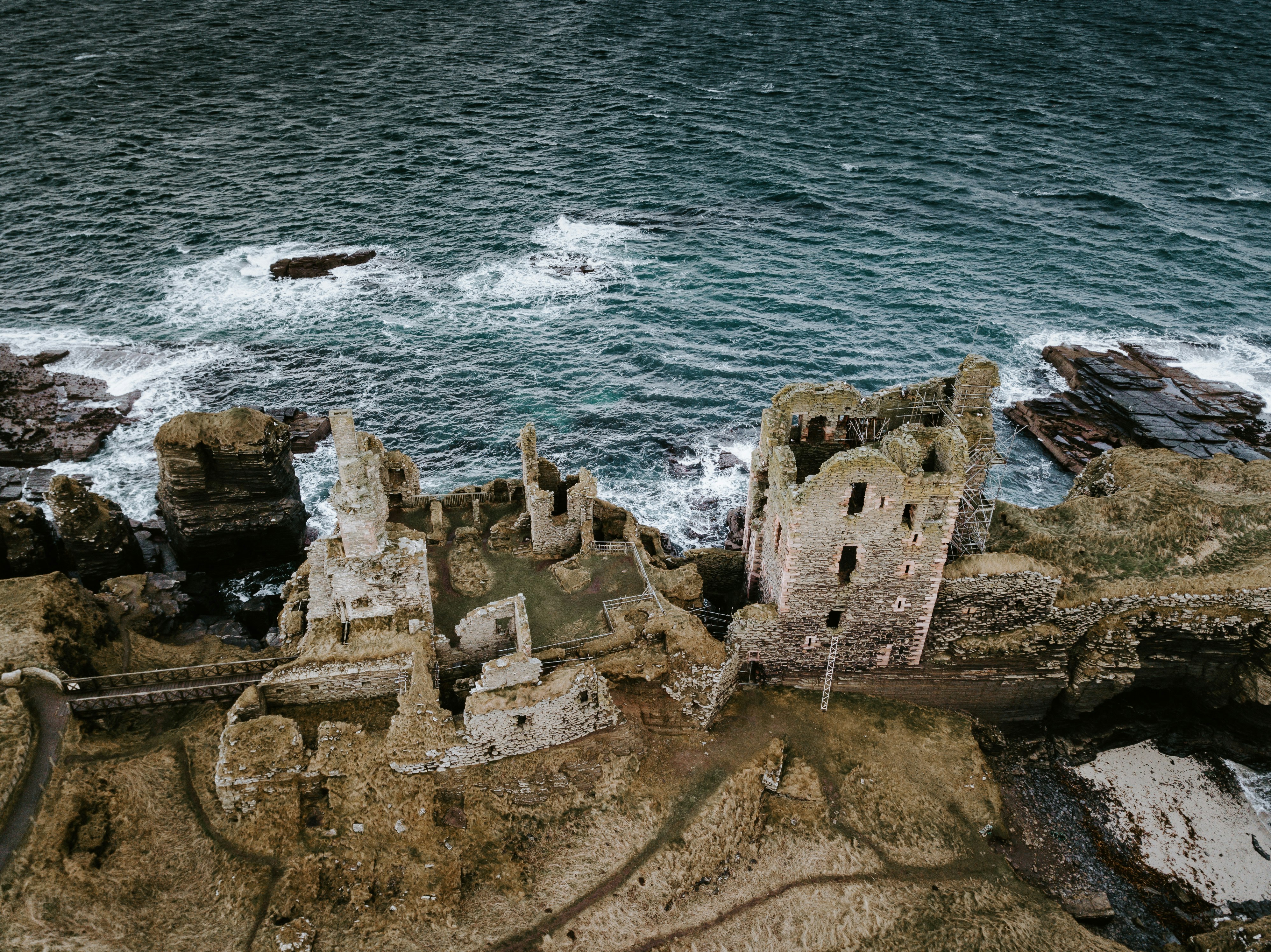 brown castle ruins across body of water